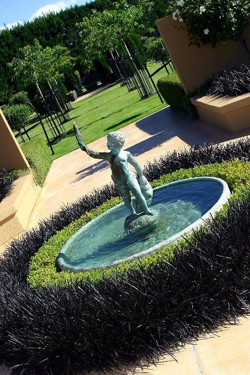 A fountain with a statue of a child in it