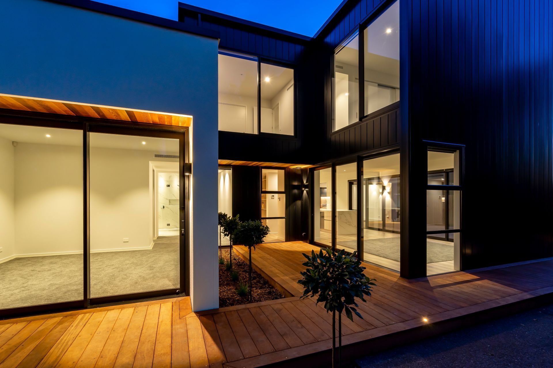 A house with a lot of windows and a wooden deck