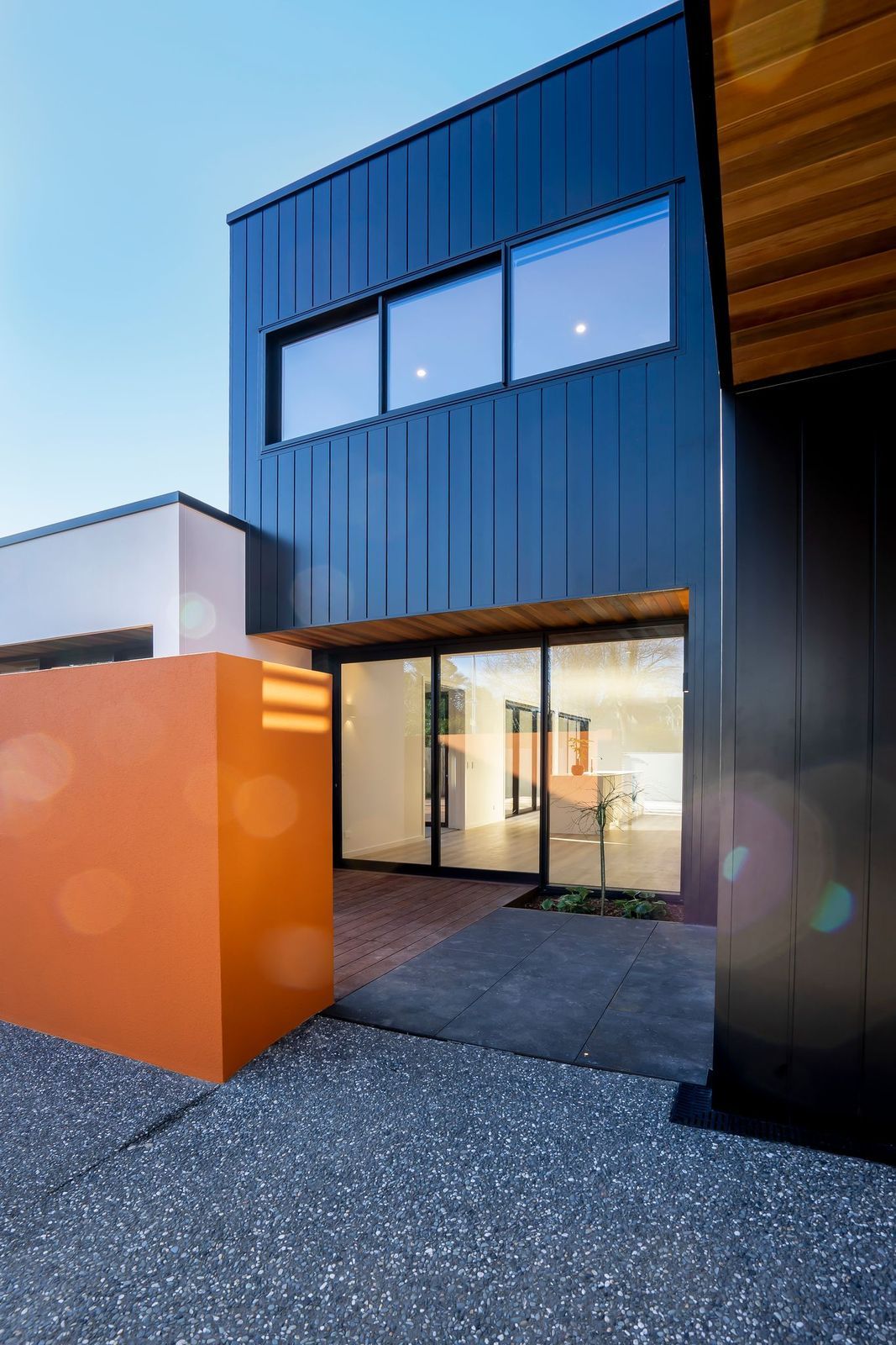 A black and orange building with a lot of windows