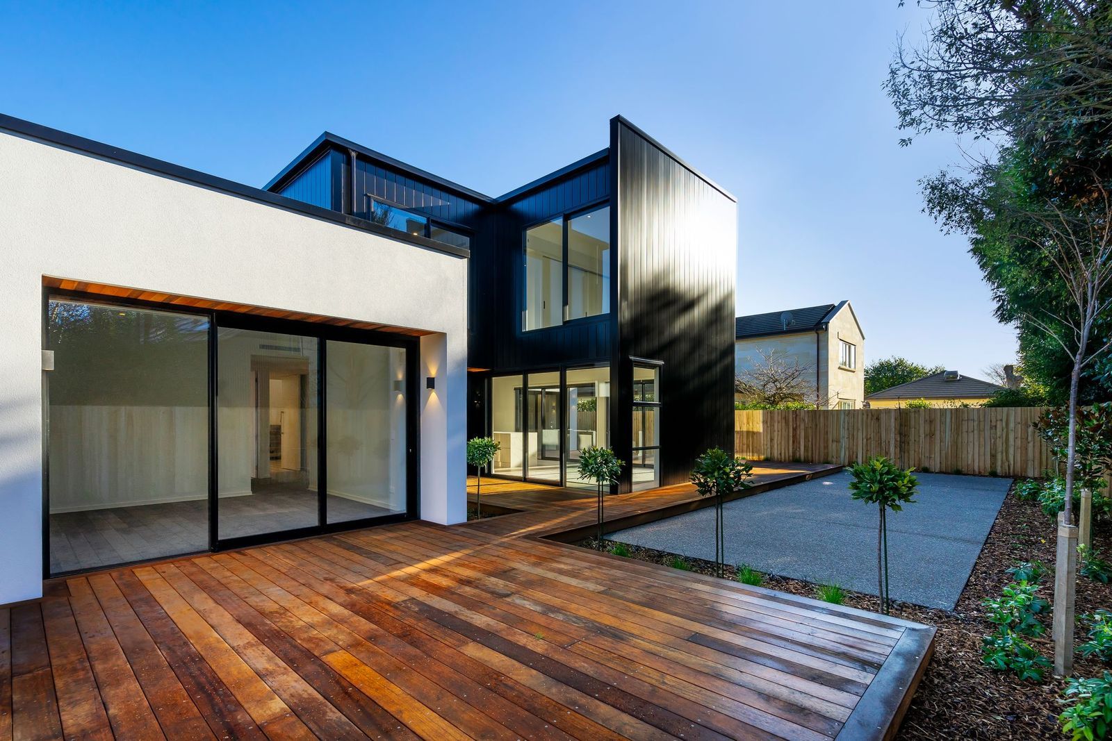 A house with a wooden deck in front of it