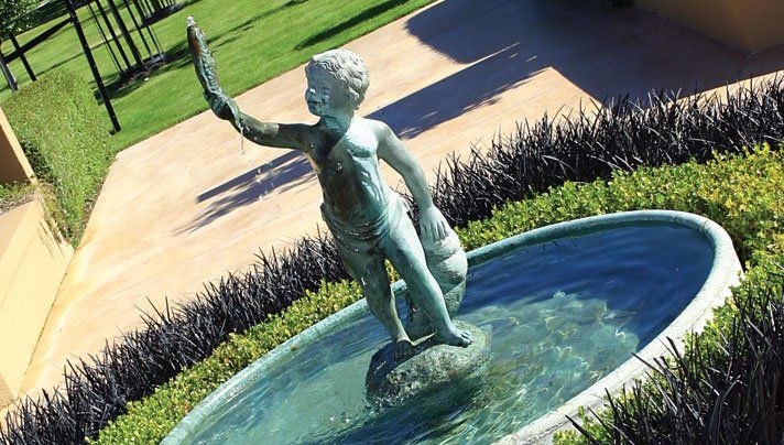 A fountain with a statue of a child in it