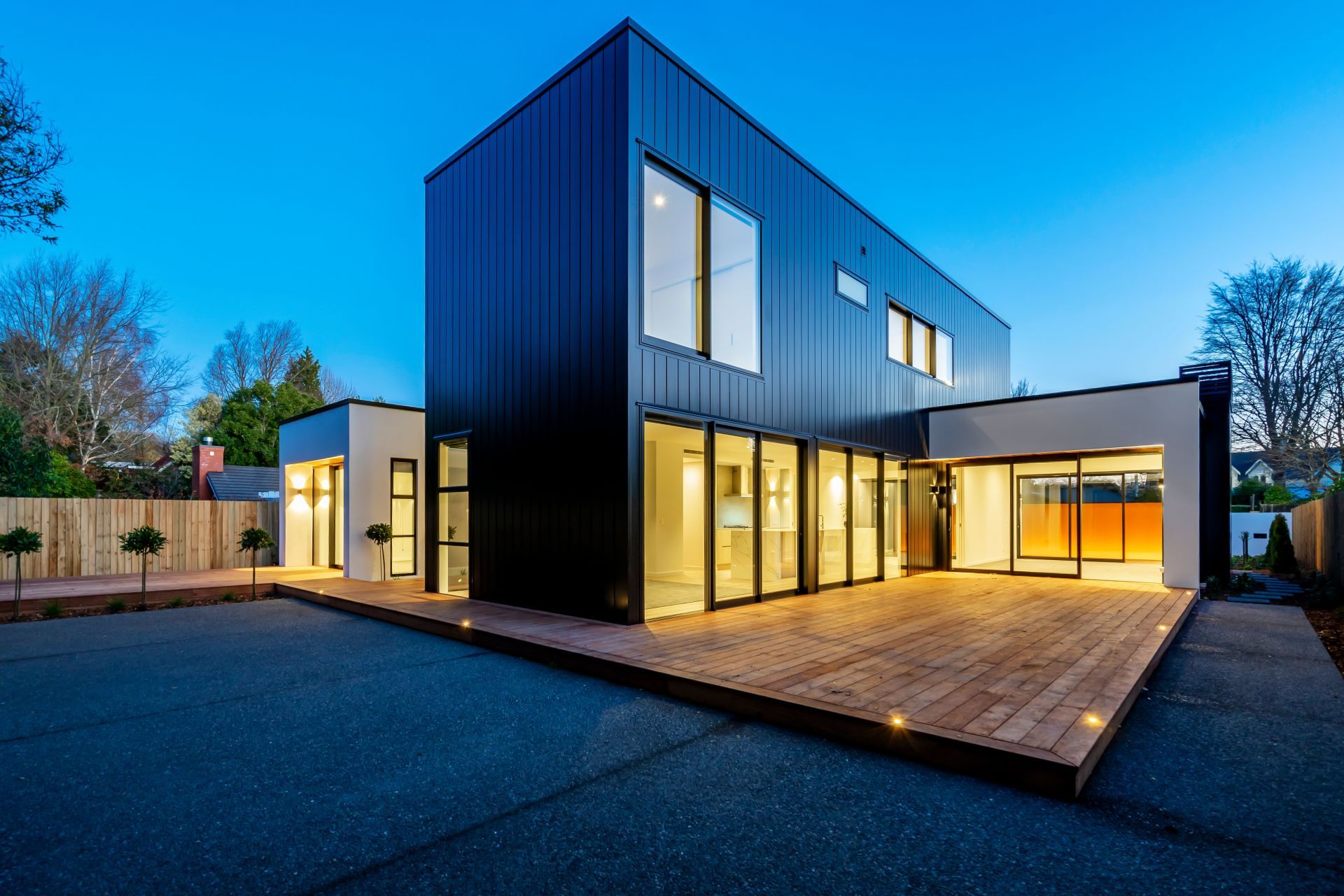 A house with a lot of windows and a wooden deck