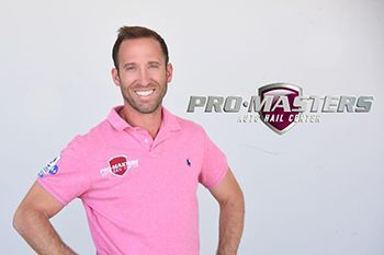 a man in a pink polo shirt is standing in front of a pro masters logo .