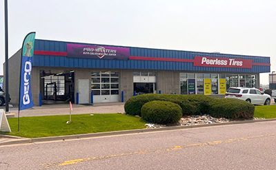 a peerless tires store is located on the side of the road .