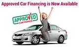 a woman is jumping in the air in front of an approved car .