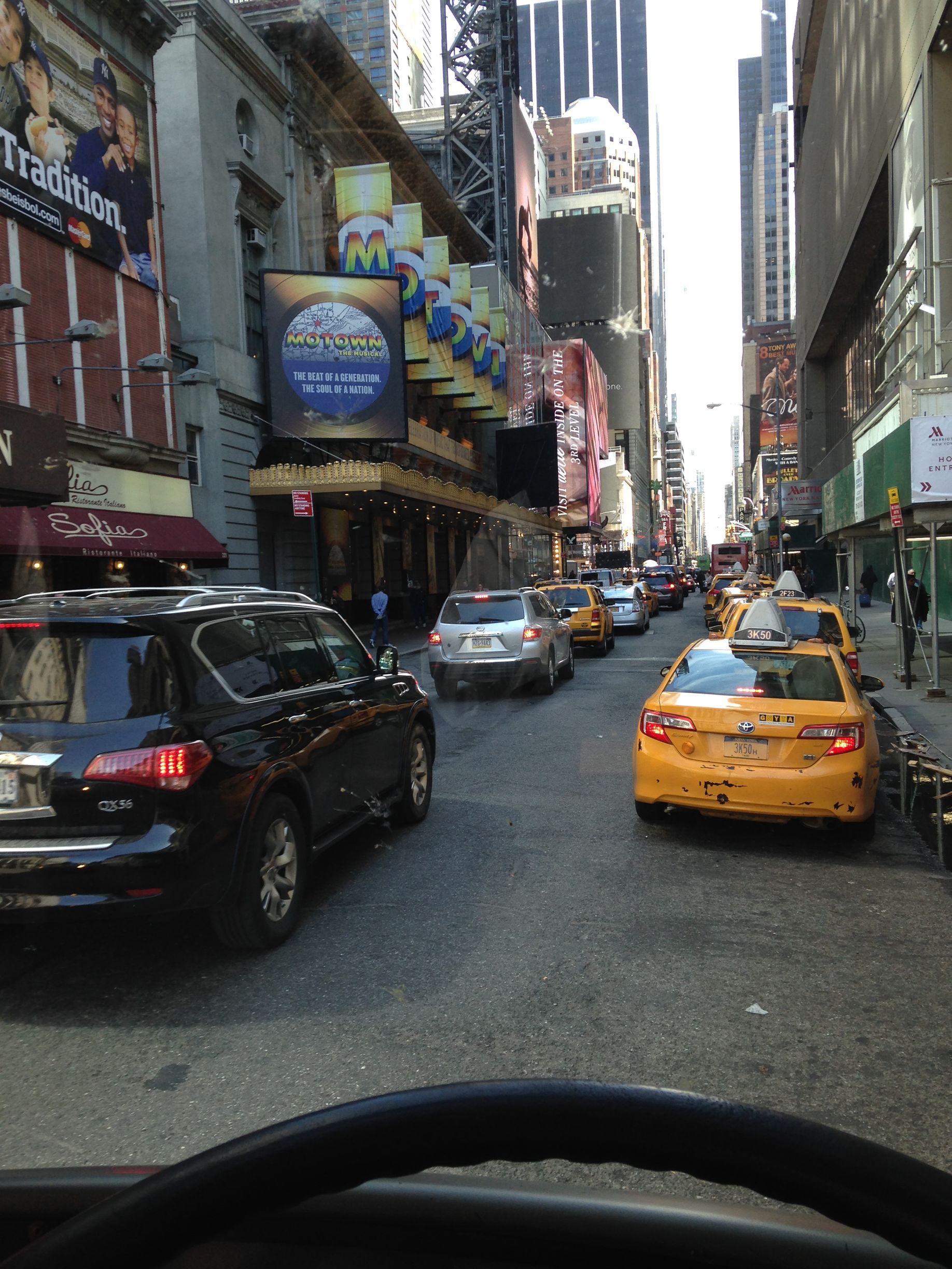 A busy city street with a sign that says ' pacifica ' on it