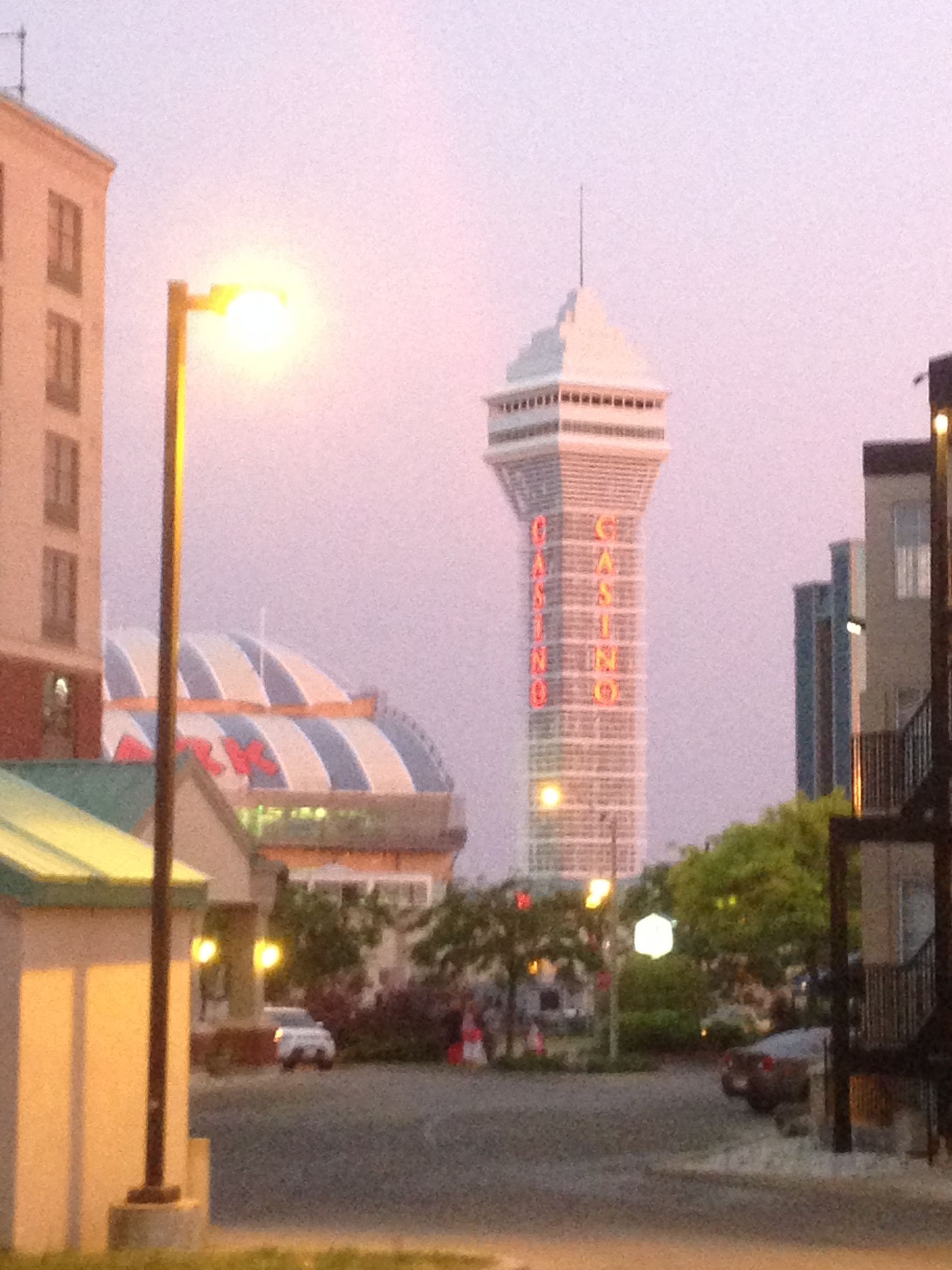 A very tall tower is lit up at night