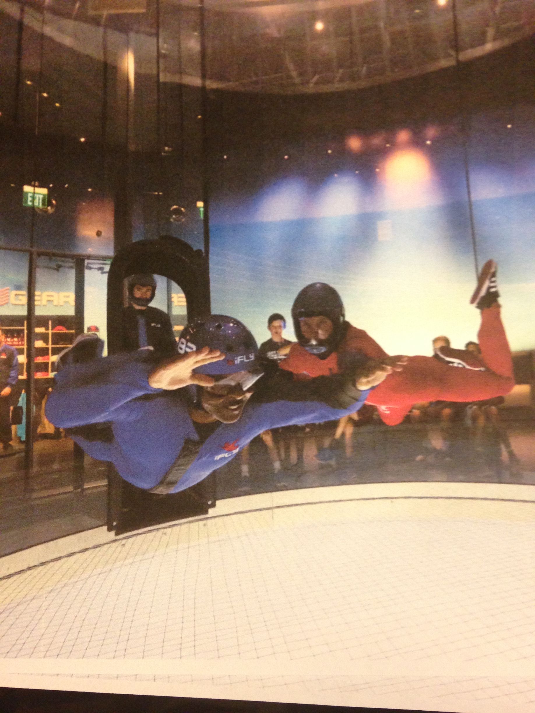 A man in a blue suit is flying through the air