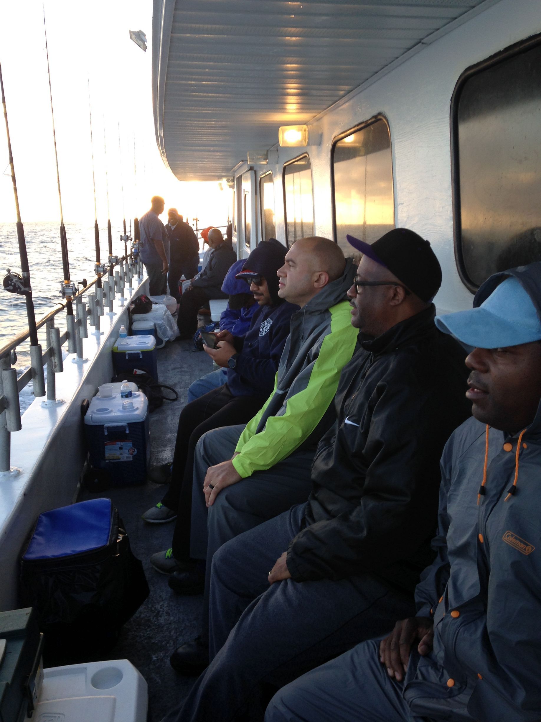 A group of men are sitting on a boat