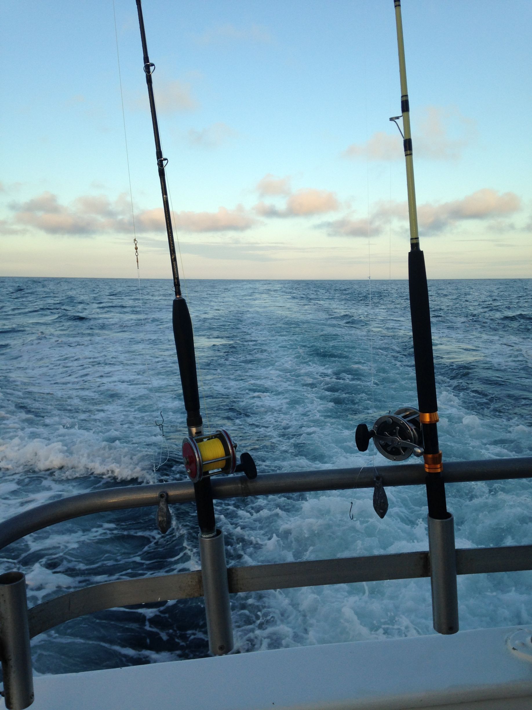 Two fishing rods on a boat in the ocean