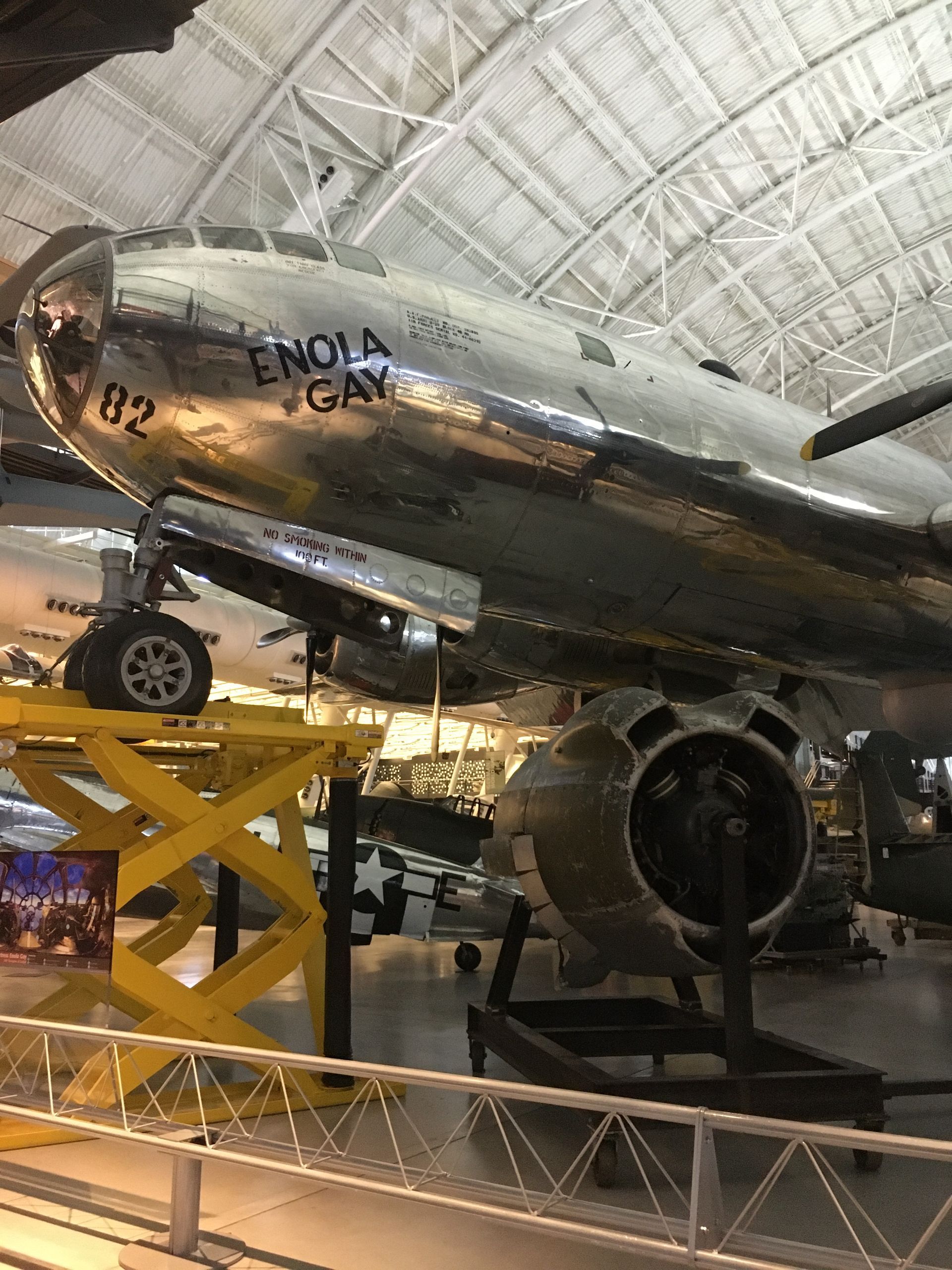 A large silver airplane is on display in a museum.