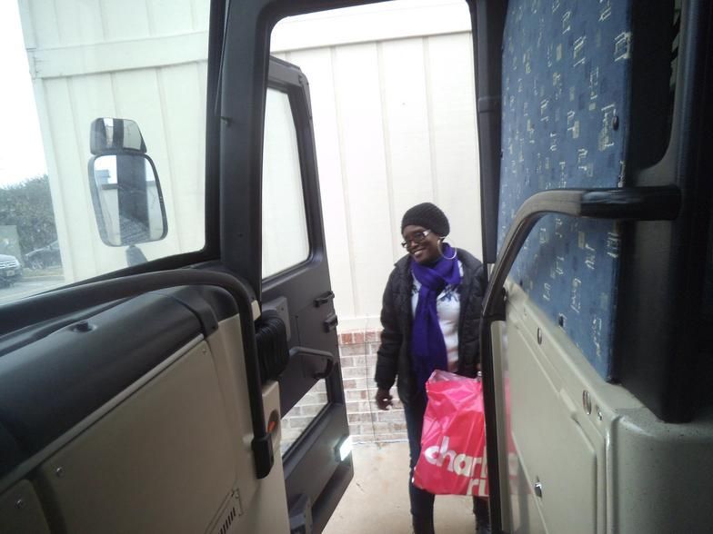 A woman carrying a pink bag that says charlotte on it