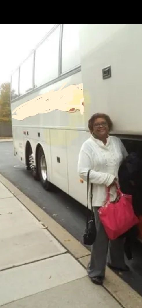 A woman standing in front of a bus that says marlon