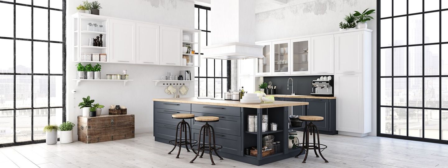 A modern kitchen with a large island and lots of windows.