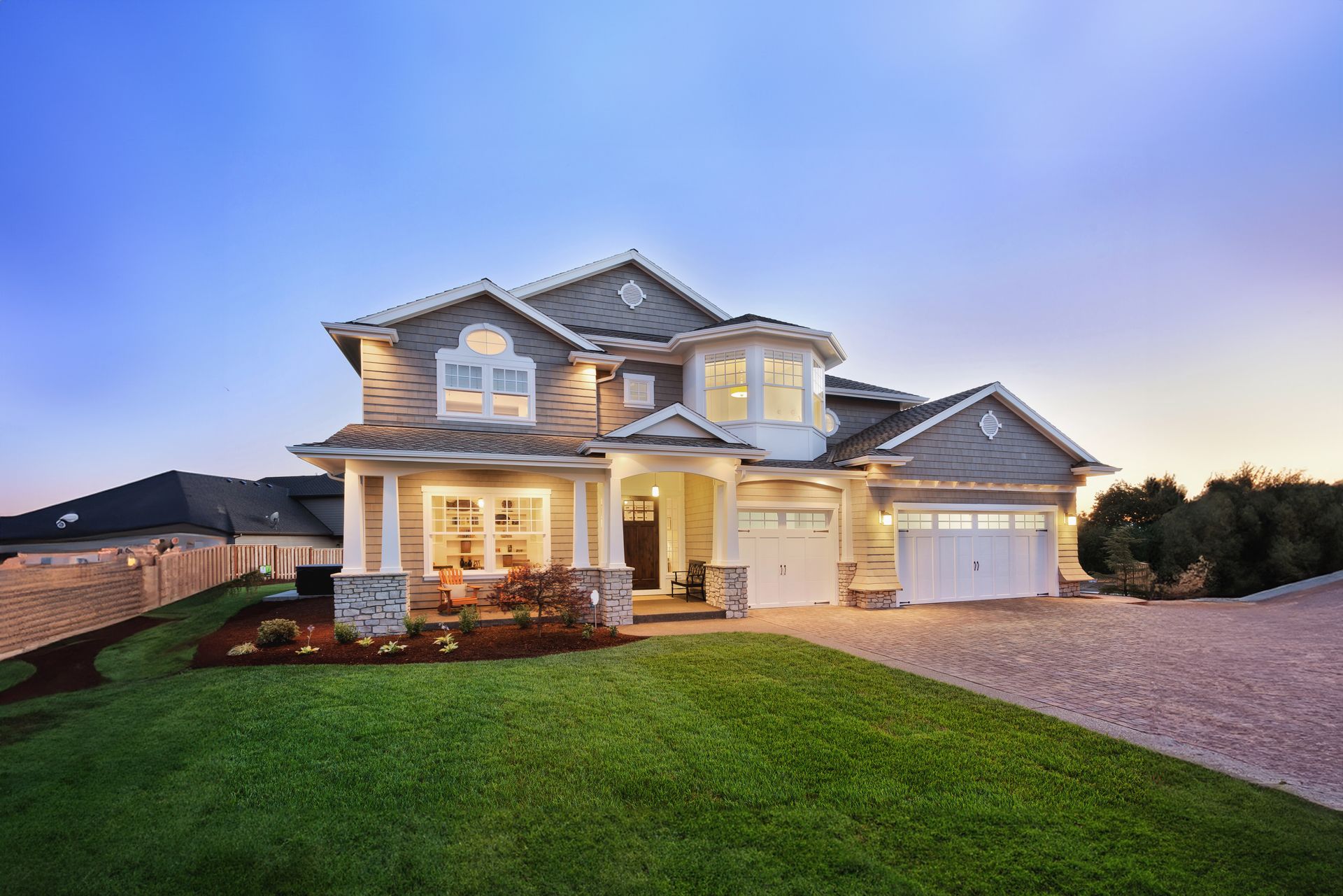 A large house with a lot of grass in front of it.