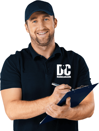 A man wearing a dc mobile locksmith shirt is writing on a clipboard