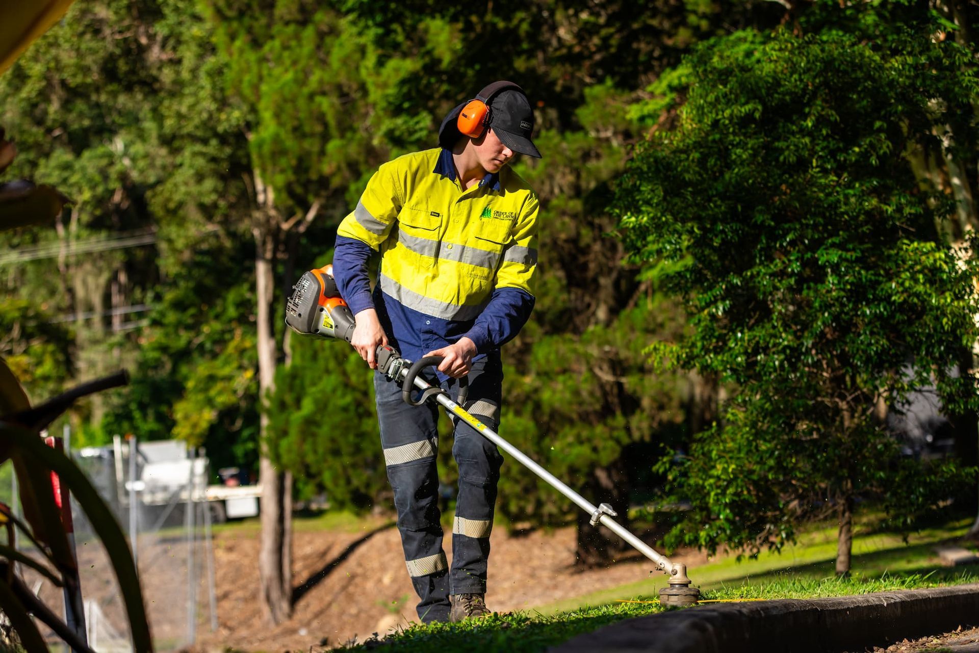 A person cutting grass after getting a job from their SEO services with Toolbox Marketing.
