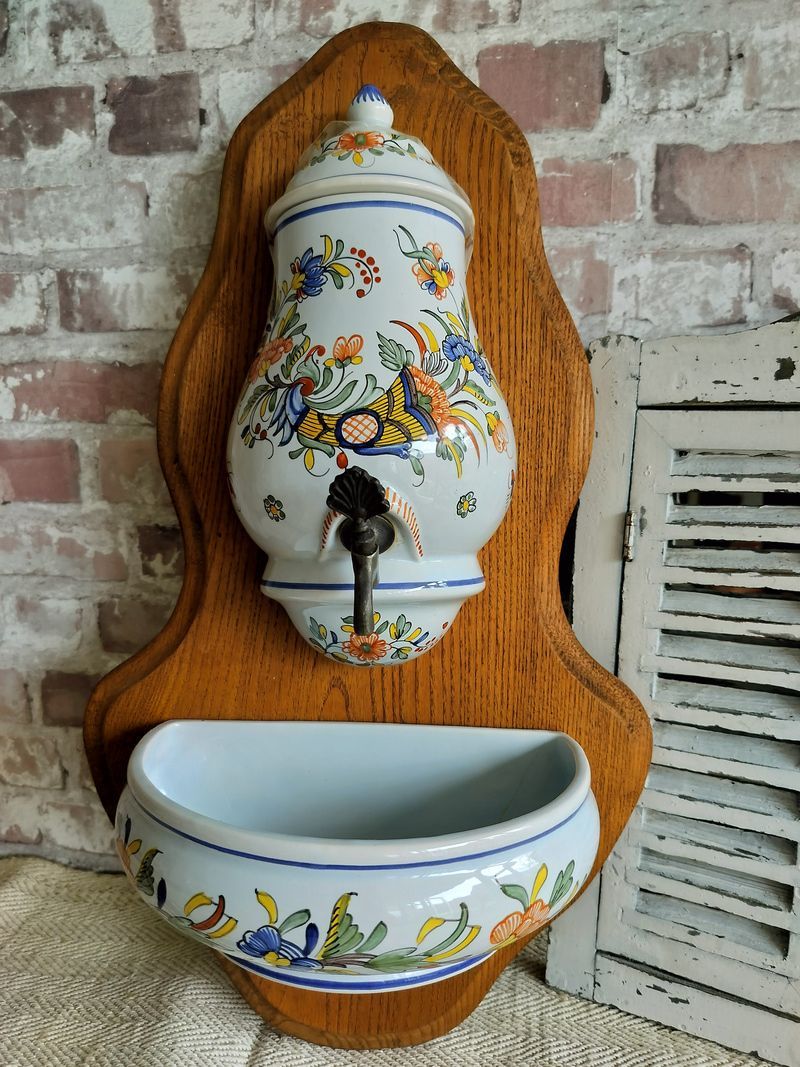 A wall mounted sink with a floral design on it.