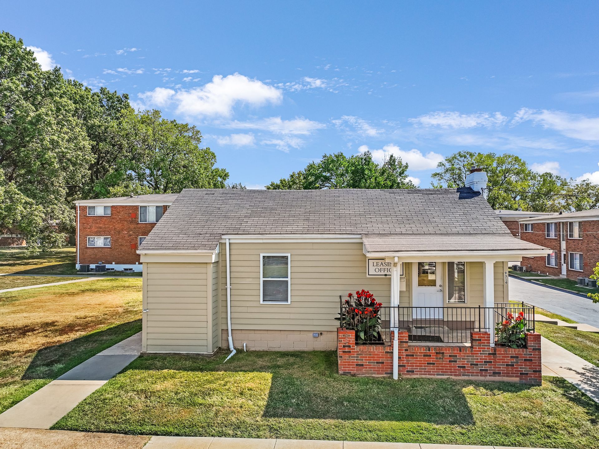 A small house with a porch in a residential area.