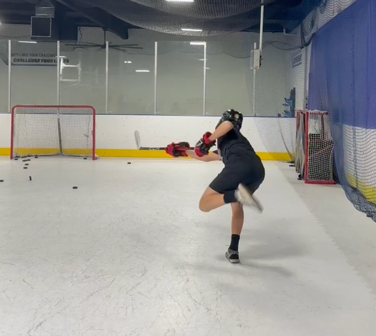 hockey player practicing shooting the puck