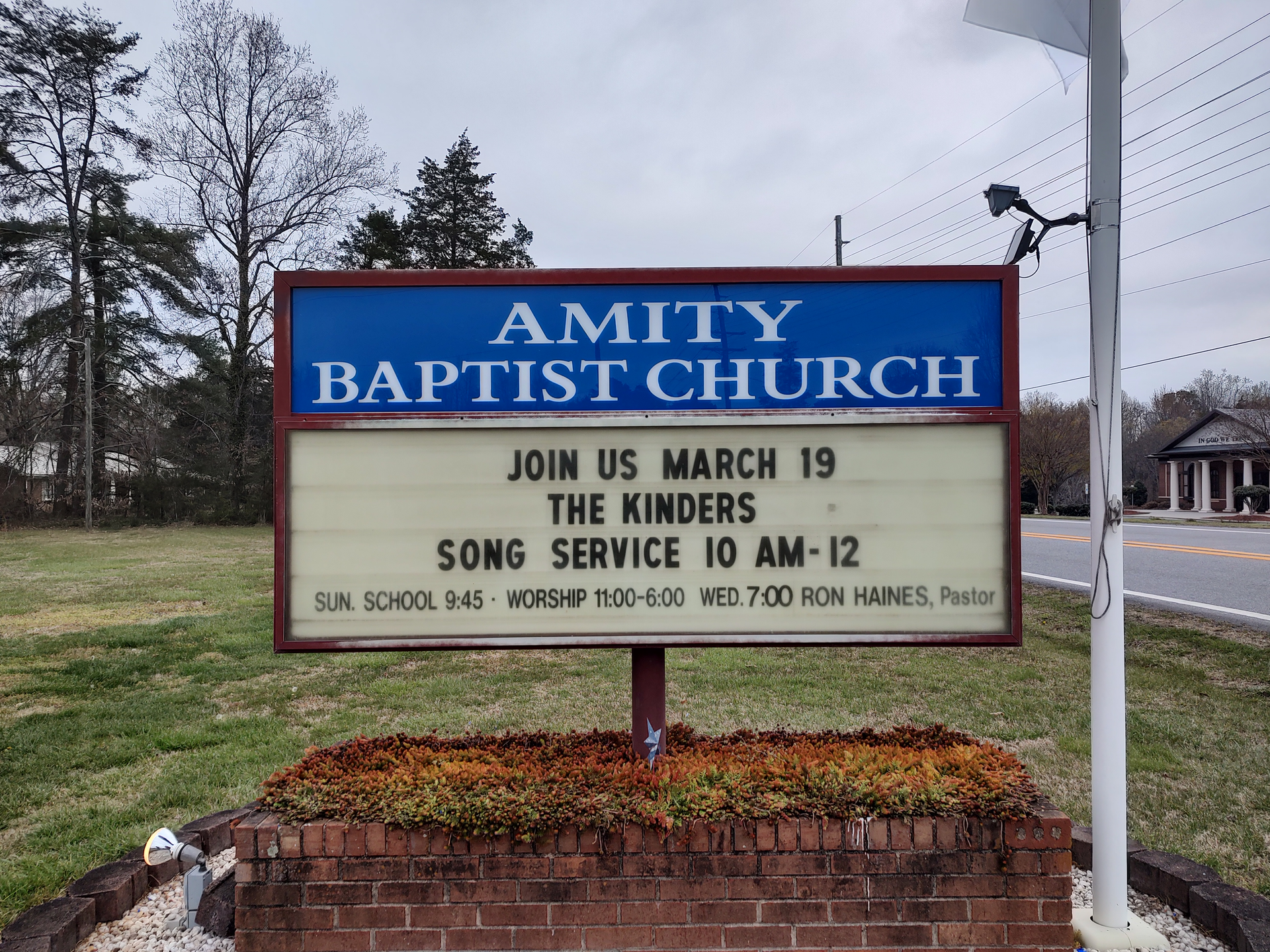 A sign for amity baptist church says join us march 19