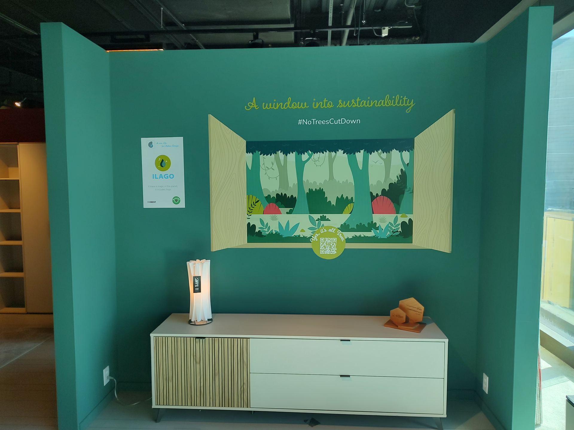 A room with a green wall and a white dresser