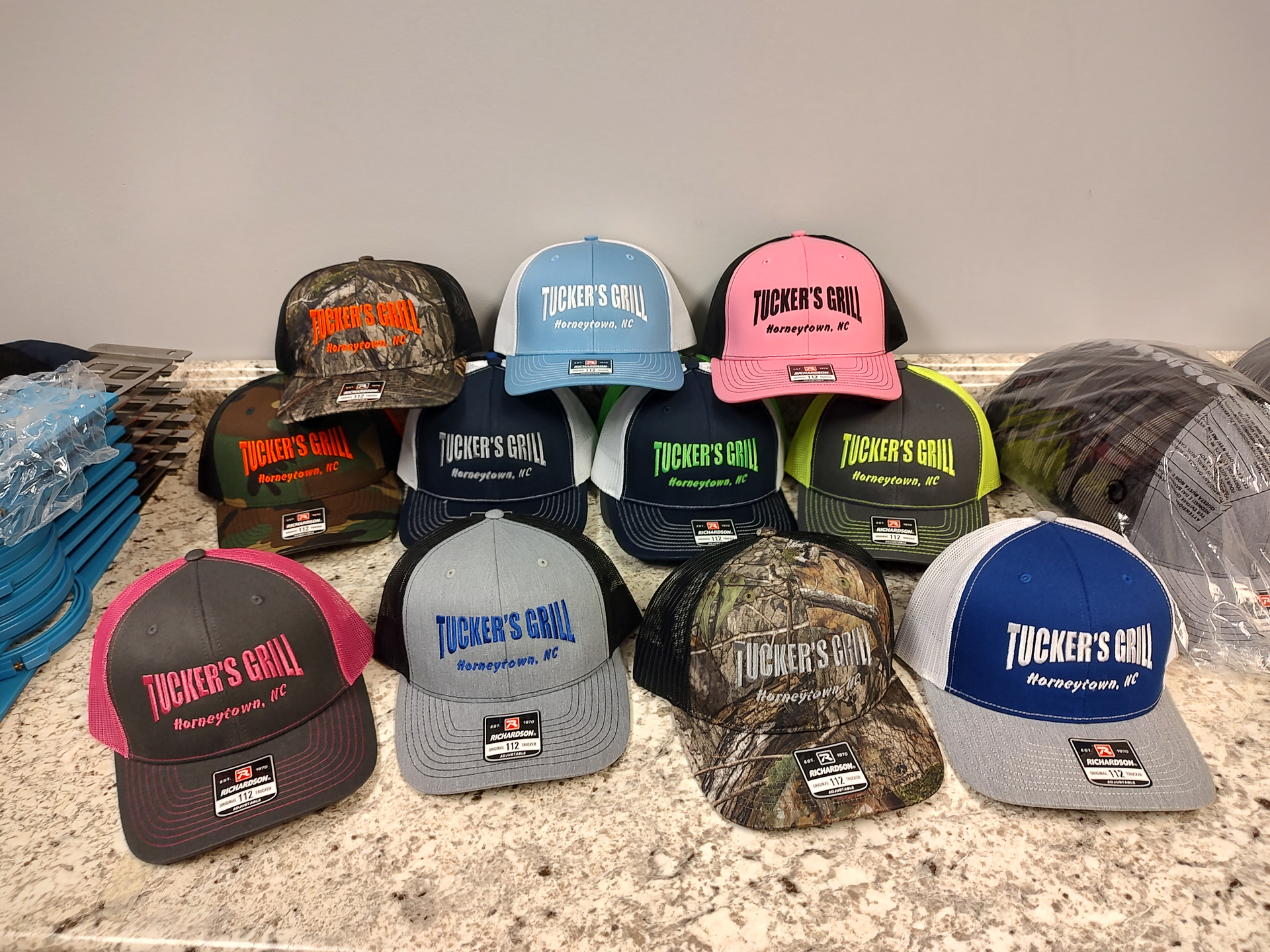 A bunch of hats are sitting on a counter.