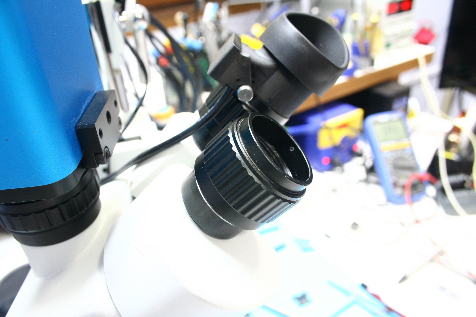 A close up of a microscope port on a table