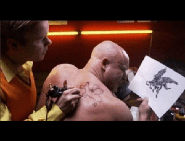 A bald man is getting a bad quality tattoo on his back