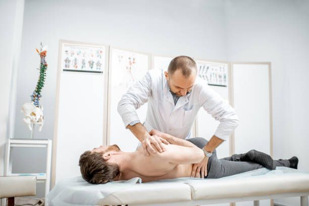 A doctor provides a massage to a man as part of back pain treatment in High Point, NC by Stroud Chir