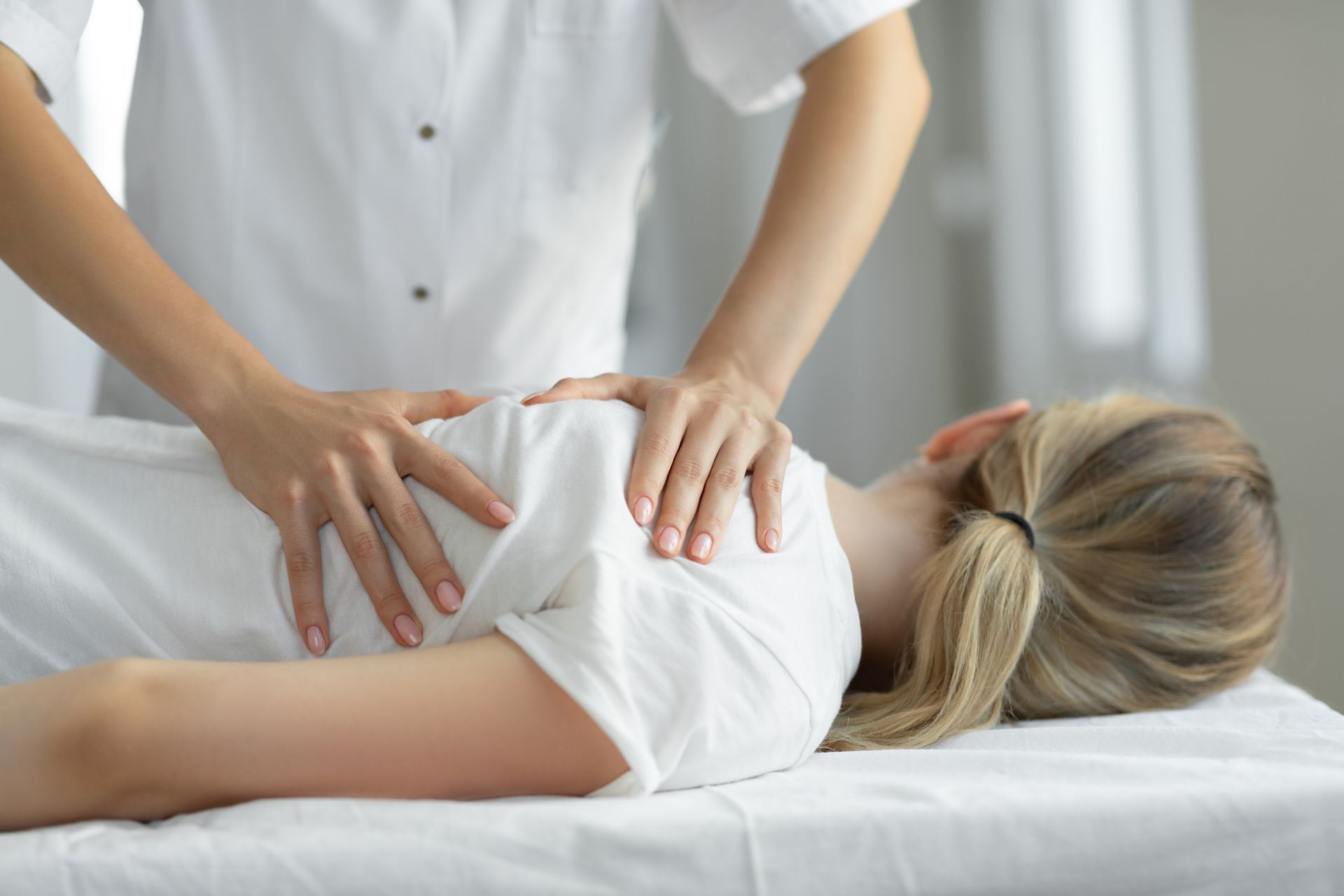 Woman having chiropractic back adjustment at Stroud Chiropractic Clinic for chiropractic care in Guilford County, NC.