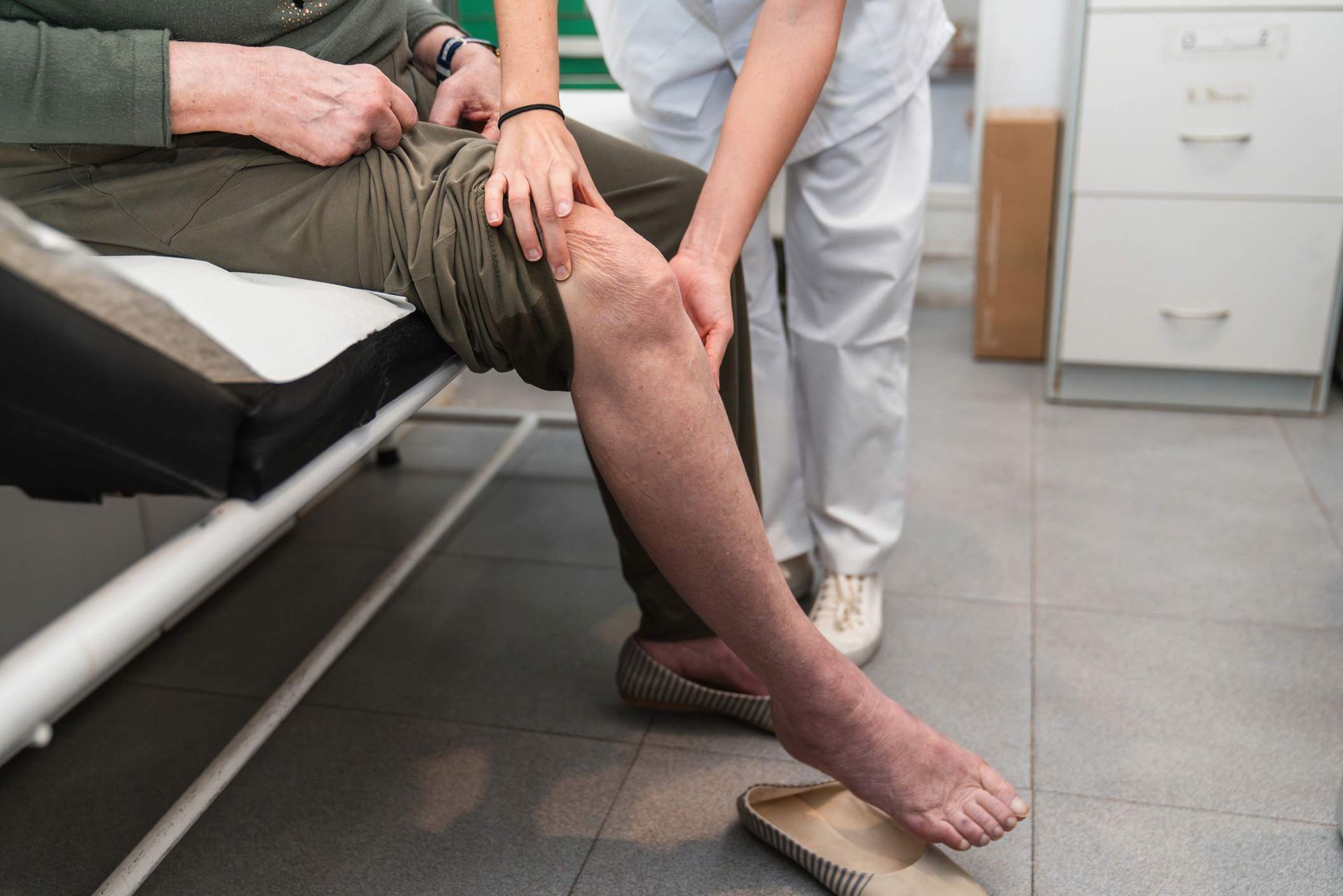 Nurse examining patient's leg at a nursing home. Nurse examining patient's leg at a nursing home.