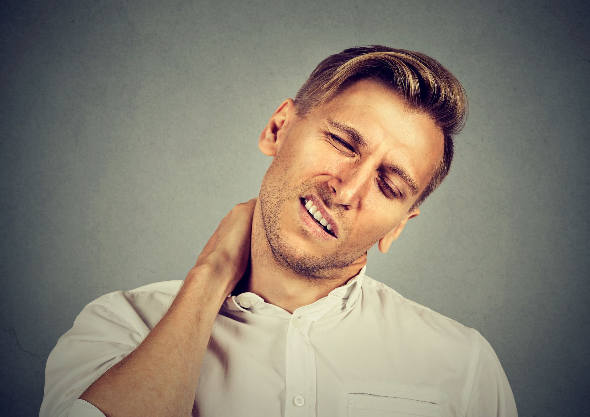 Man with neck pain, after long hours of work.