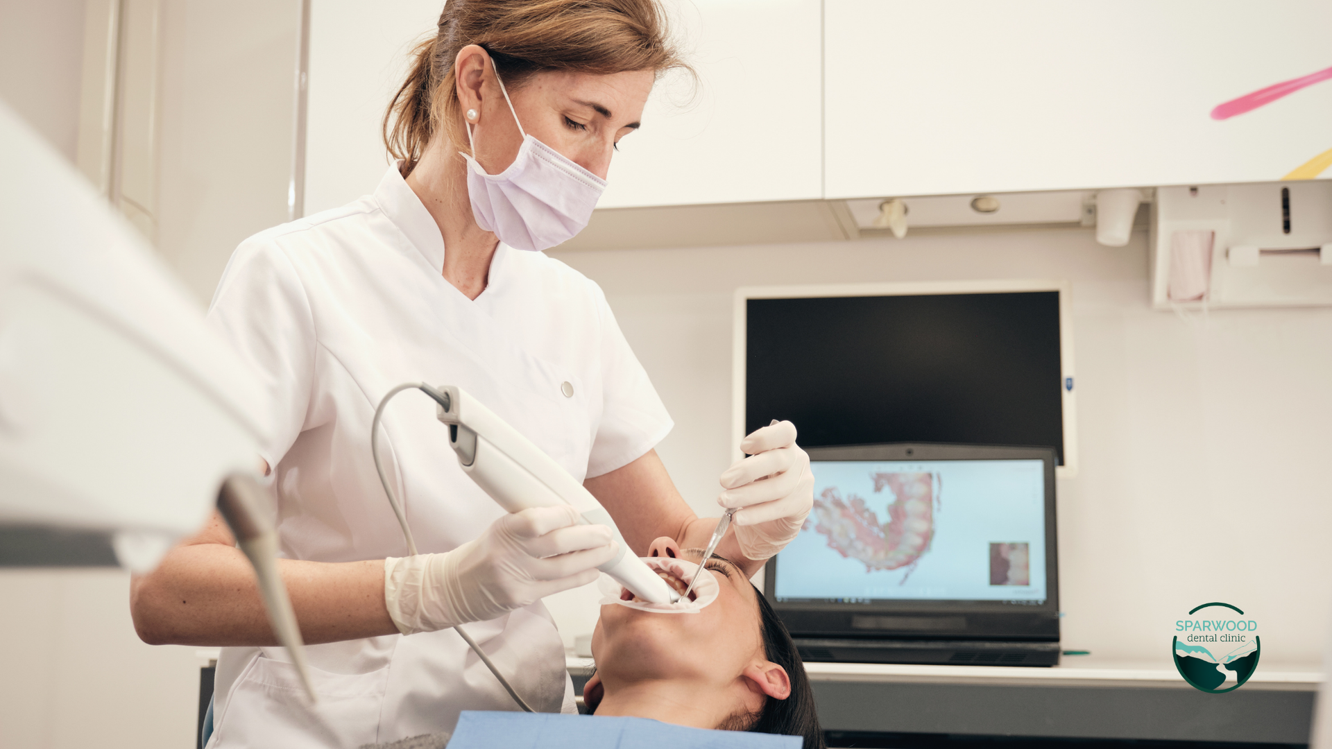 A female dentist is examining a patient 's teeth in a dental office.