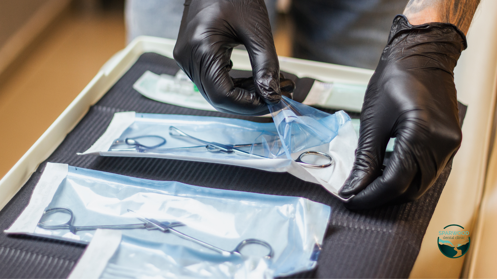 A person wearing black gloves is putting a pair of scissors in a plastic bag.