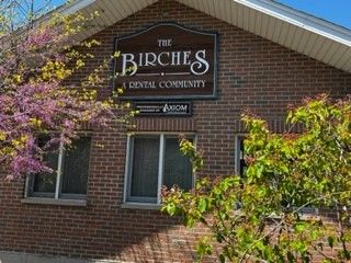 Building with Birches sign