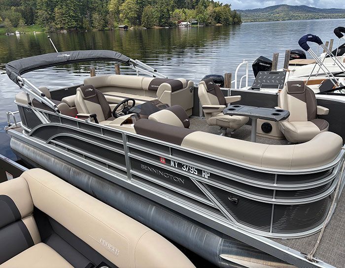 2023 Trophy T24CX with blue hull tied up at dock