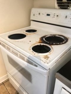 A white stove with a fan on top of it