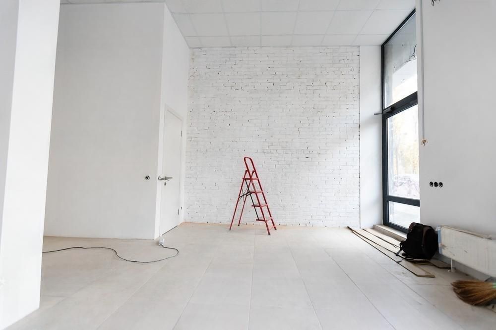 A room under construction with a table and scaffolding.