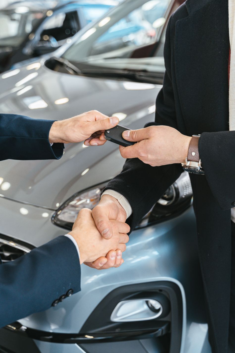 A Men Shaking Hands and Handing in Keys to a New Car — All Finanz and Insurance Solutions PtyLtd in North Mackay, QLD