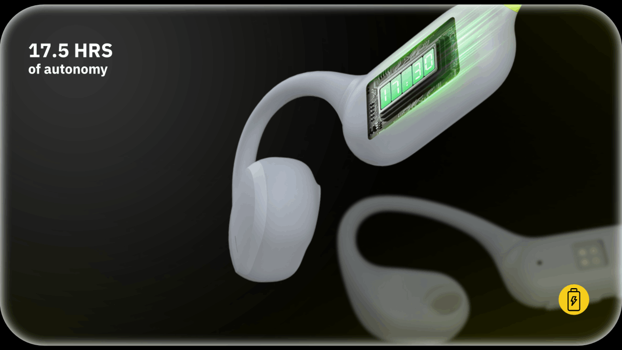 White bone-conduction headphones on dark background, with green display showing 17.5 hrs autonomy