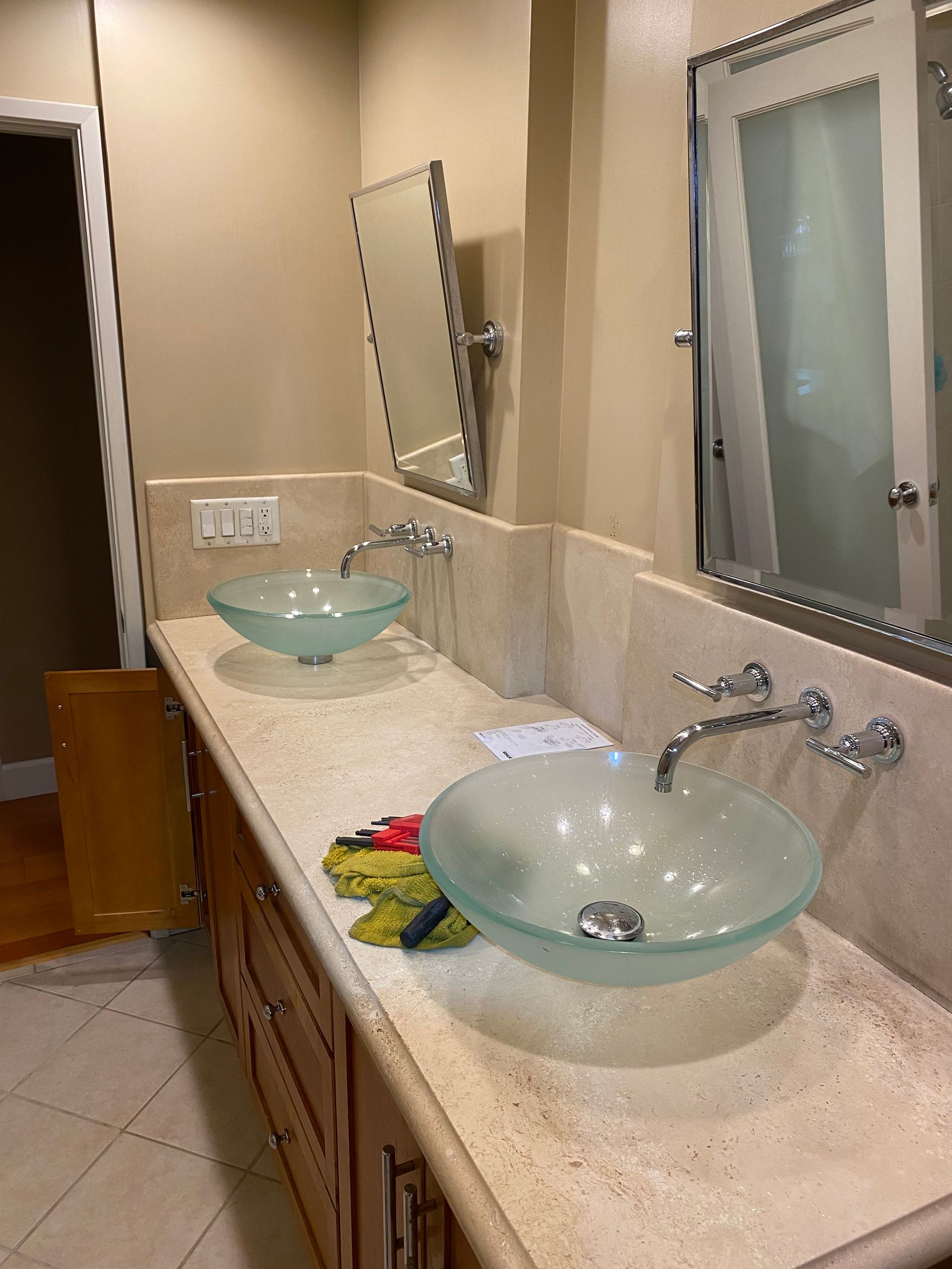 A bathroom with two sinks and a mirror.