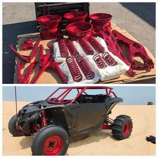 A red and black atv is sitting on top of a cardboard box