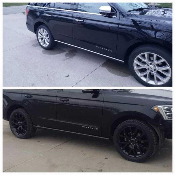 A black ford expedition is parked in a parking lot