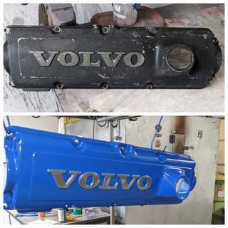 A black volvo engine cover and a blue volvo engine cover