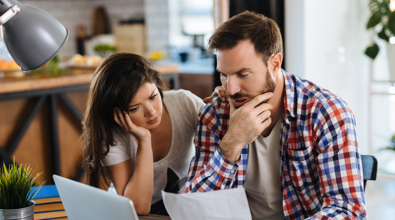Small business owners reviewing rising UK energy bills and comparing supplier contracts. 