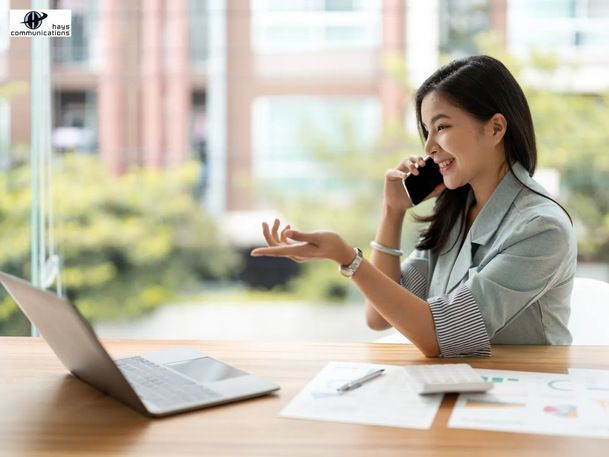 A businesswoman taking calls on her smartphone.