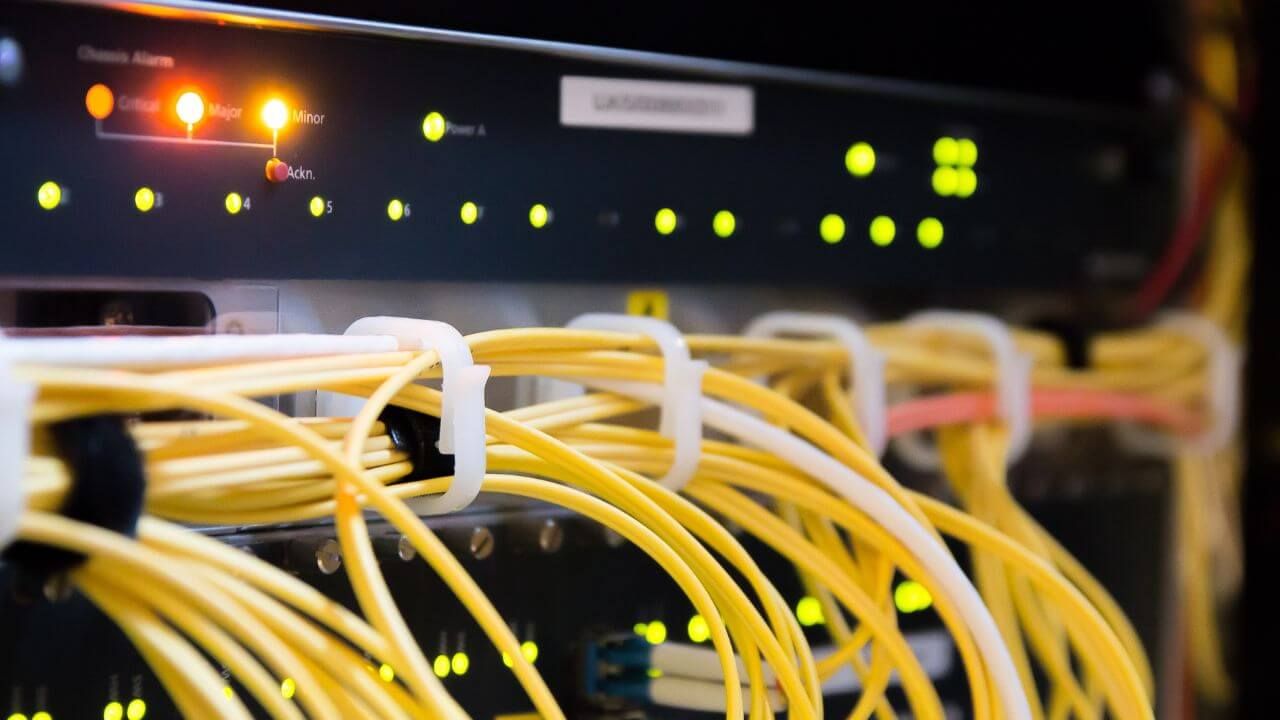 A close-up of a network server with yellow wires.