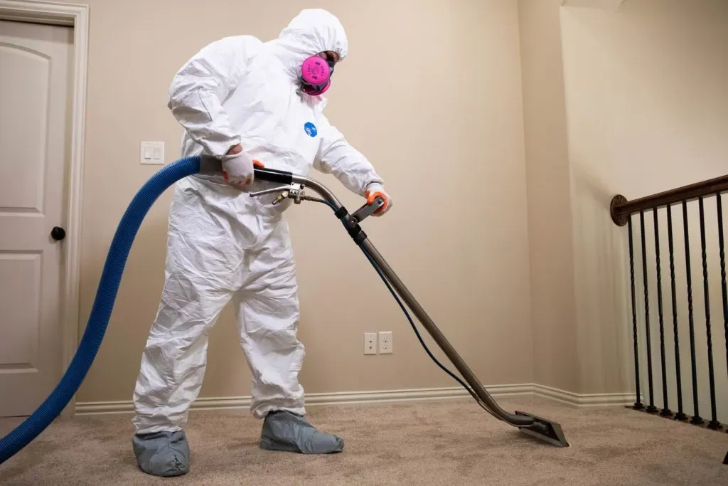 person removing water on the second floor of a home
