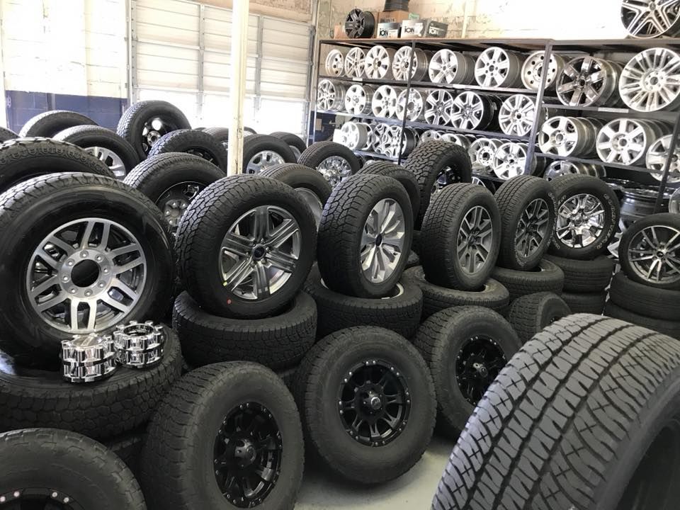 A warehouse filled with lots of tires and wheels